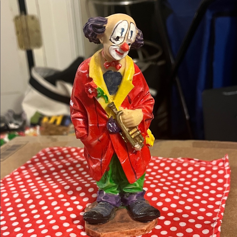 Vintage Hobo Clown with bright red jacket holding a saxophone 367